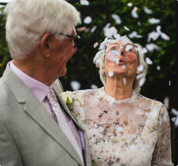 Two older people celebrating a wedding